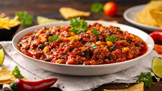 A plate of chilli con carne with green garnish