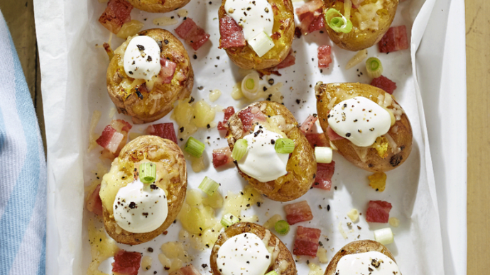 Baby potatoes topped with cheese, onions and bacon pieces