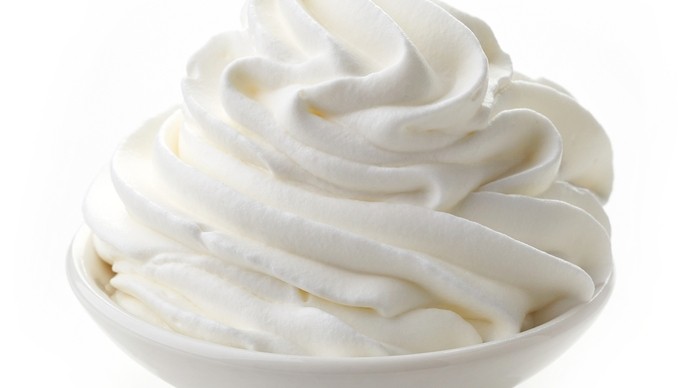 A swirl of whipped cream on a small plate