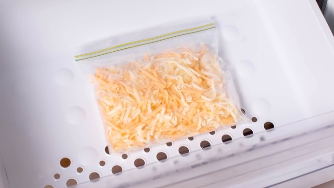 Grated hard cheese in a sealed bag in the freezer