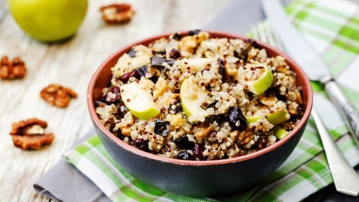 a big bowl of quinoa combined with juicy slices of apple