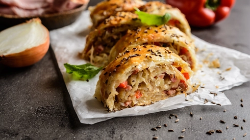 Sliced swirls of pastry rolls containing bacon and onion