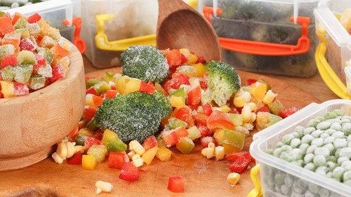 A mix of frozen vegetables, some in reusable storage containers