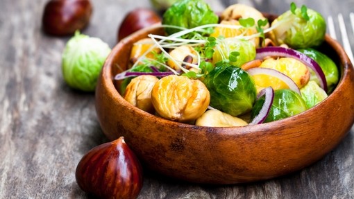 Chestnuts and sprouts in a wooden bowl