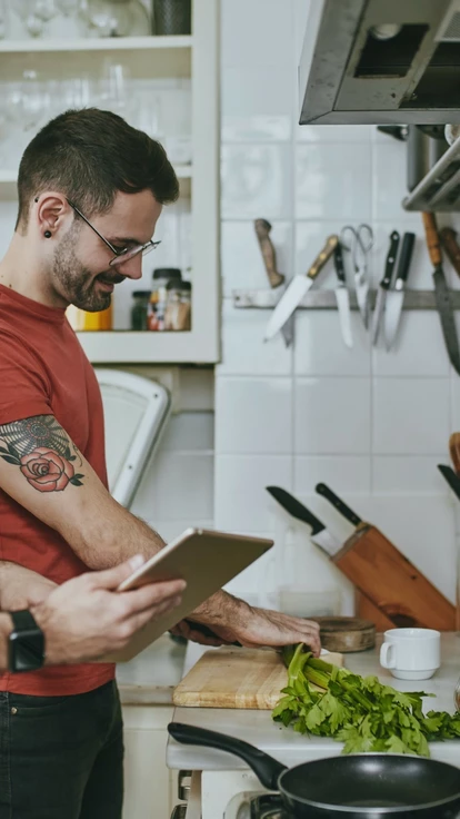 Two lads cooking together in the kitchen