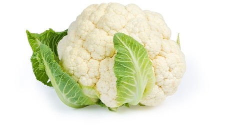 A head of white cauliflower with a couple of leaves