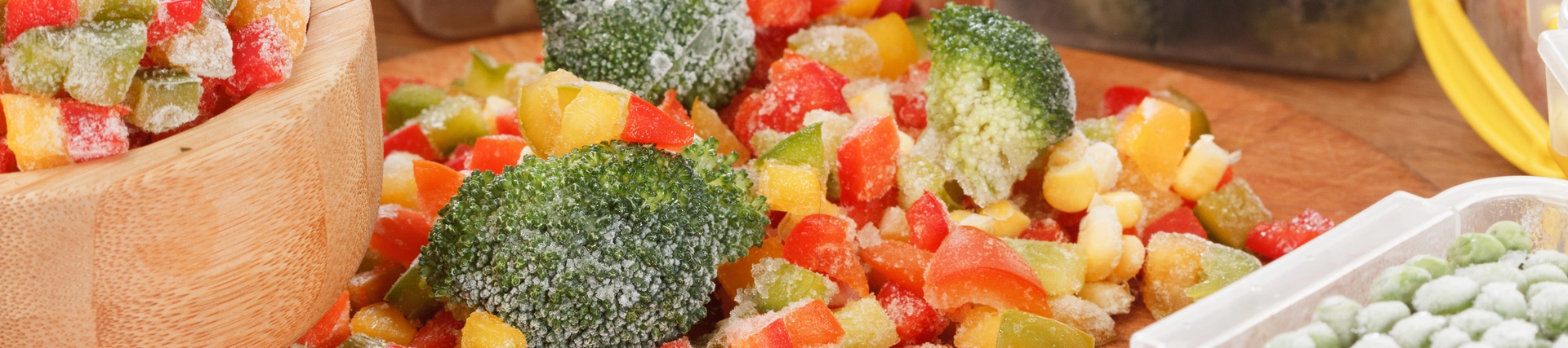 A mix of frozen vegetables, some in reusable storage containers