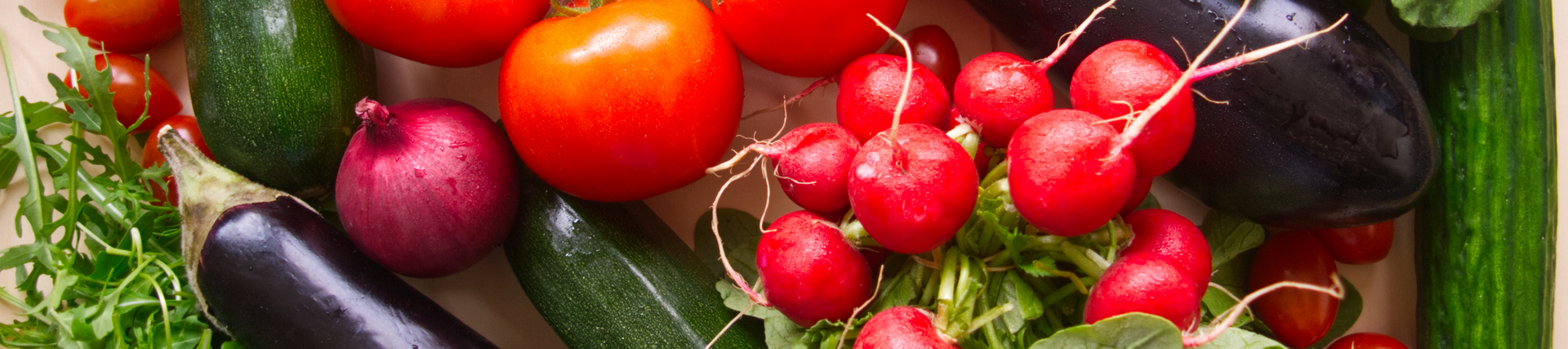 Aubergines amongst tomatoes and radishes