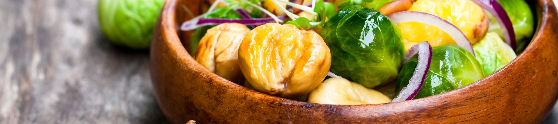 Chestnuts and sprouts in a wooden bowl